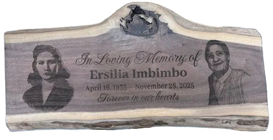 Wooden plaque with engraved portraits and text on a wooden surface.