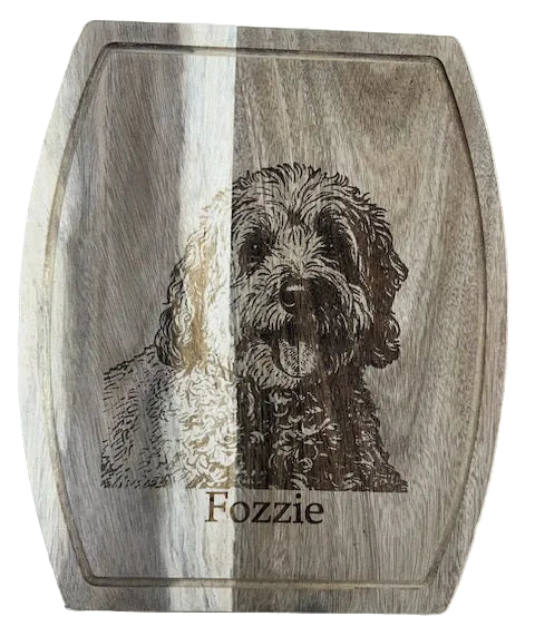 Wooden cutting board with engraved dog portrait and name 'Fozzie'
