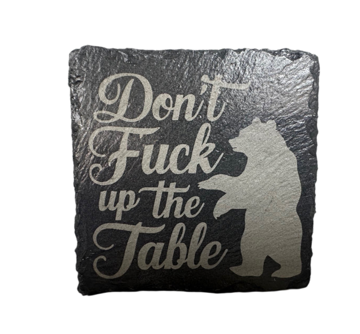 Decorative stone with a bear silhouette and text on a white background